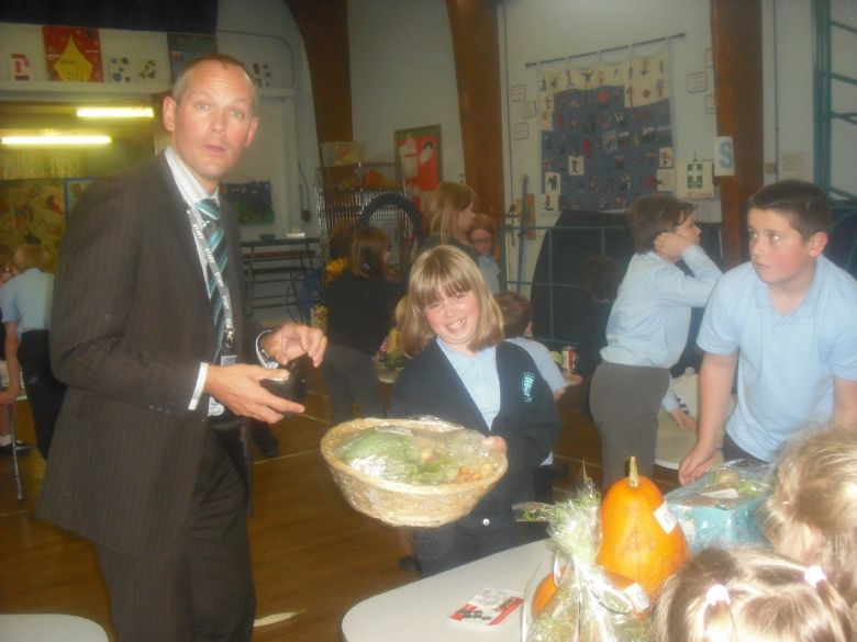 Mr A at the Harvest Sale with some of the children.